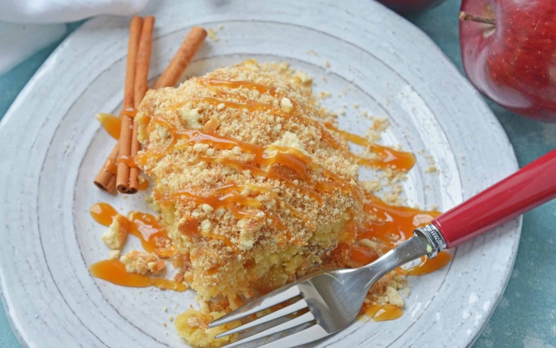 This Caramel Apple Poke Cake is one of the best recipes using boxed cake mix! With tons of apples, and cinnamon, this from scratch apple cake will become an instant family favorite! #pokecakerecipes #recipesusingboxedcakemix #applecake #easypokecakerecipes #savoryexperiments www.savoryexperiments.com