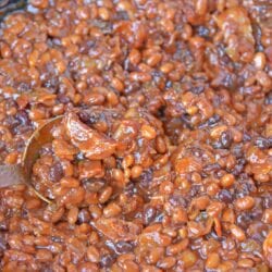 Cowboy Homemade Baked Beans in a skillet with a spoon