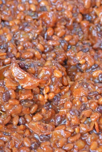 Cowboy Homemade Baked Beans in a skillet with a spoon