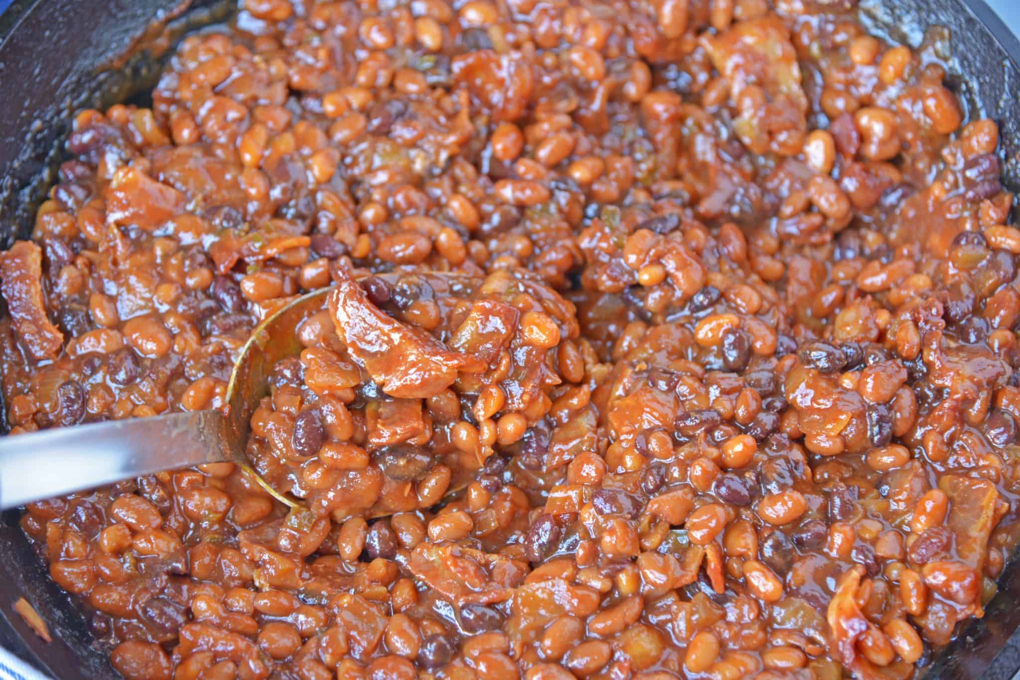 Cowboy Homemade Baked Beans in a skillet with a spoon