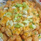 Crabby Totchos are crispy fried tater tots smothered in hot crab dip and topped with melty cheddar cheese. The perfect party appetizer! #tatertots #easyappetizerrecipes www.savoryexperiments.com