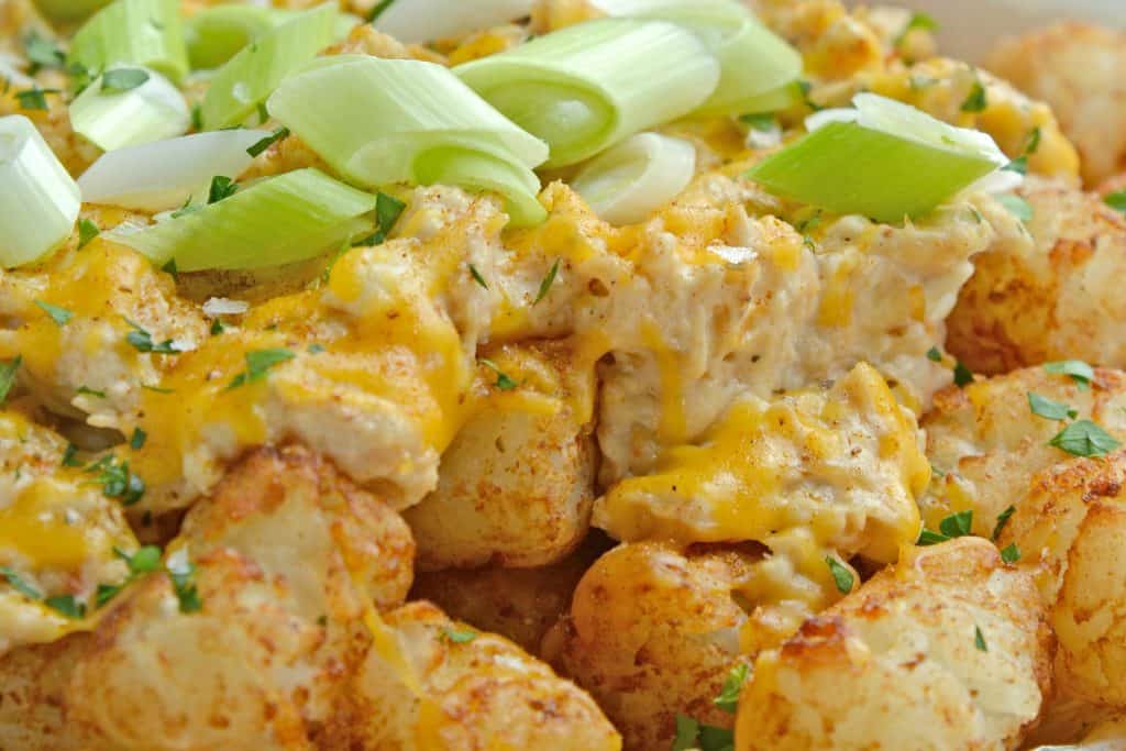 Crabby Totchos are crispy fried tater tots smothered in hot crab dip and topped with melty cheddar cheese. The perfect party appetizer! #tatertots #easyappetizerrecipes www.savoryexperiments.com