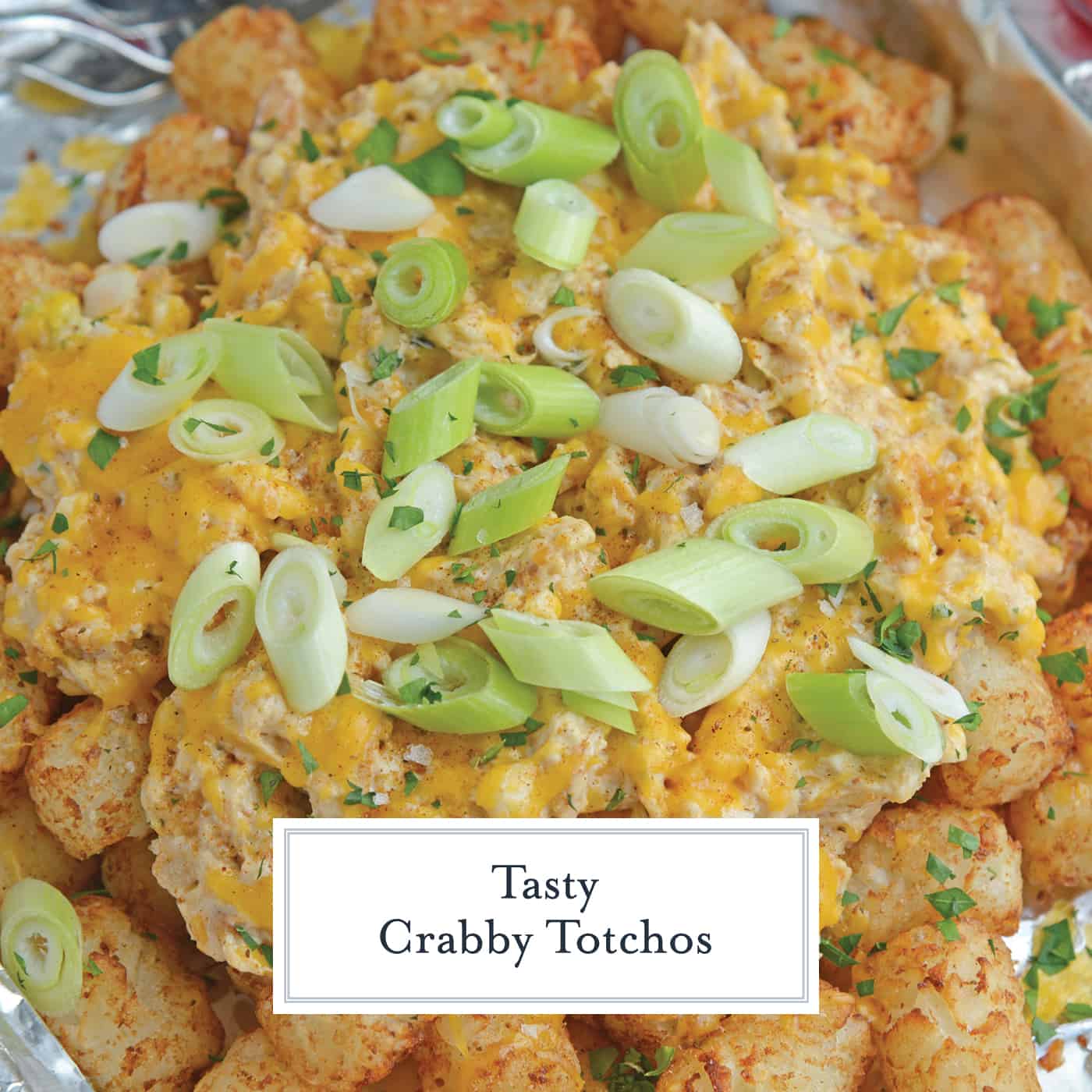 Crabby Totchos are crispy fried tater tots smothered in hot crab dip and topped with melty cheddar cheese. The perfect party appetizer! #tatertots #easyappetizerrecipes www.savoryexperiments.com 
