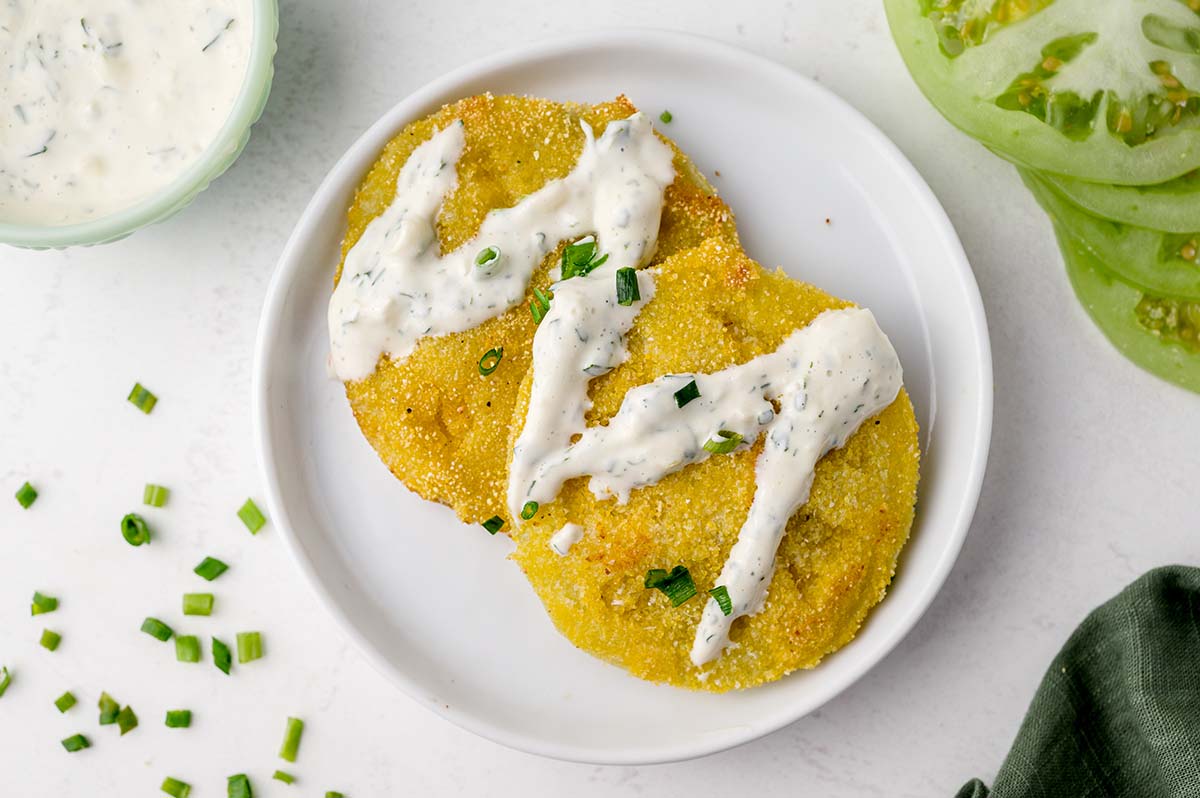 aioli sauce drizzled over fried green tomatoes