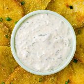 close of up of aioli dipping sauce surrounded by fried green tomatoes