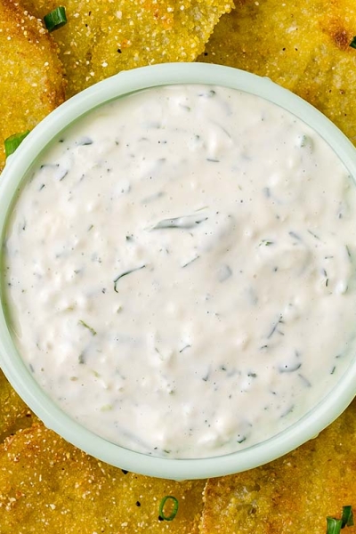 close of up of aioli dipping sauce surrounded by fried green tomatoes