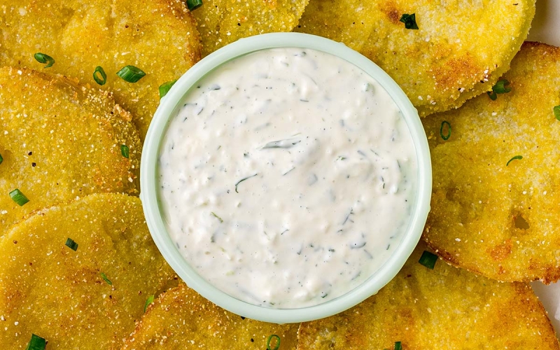 close of up of aioli dipping sauce surrounded by fried green tomatoes