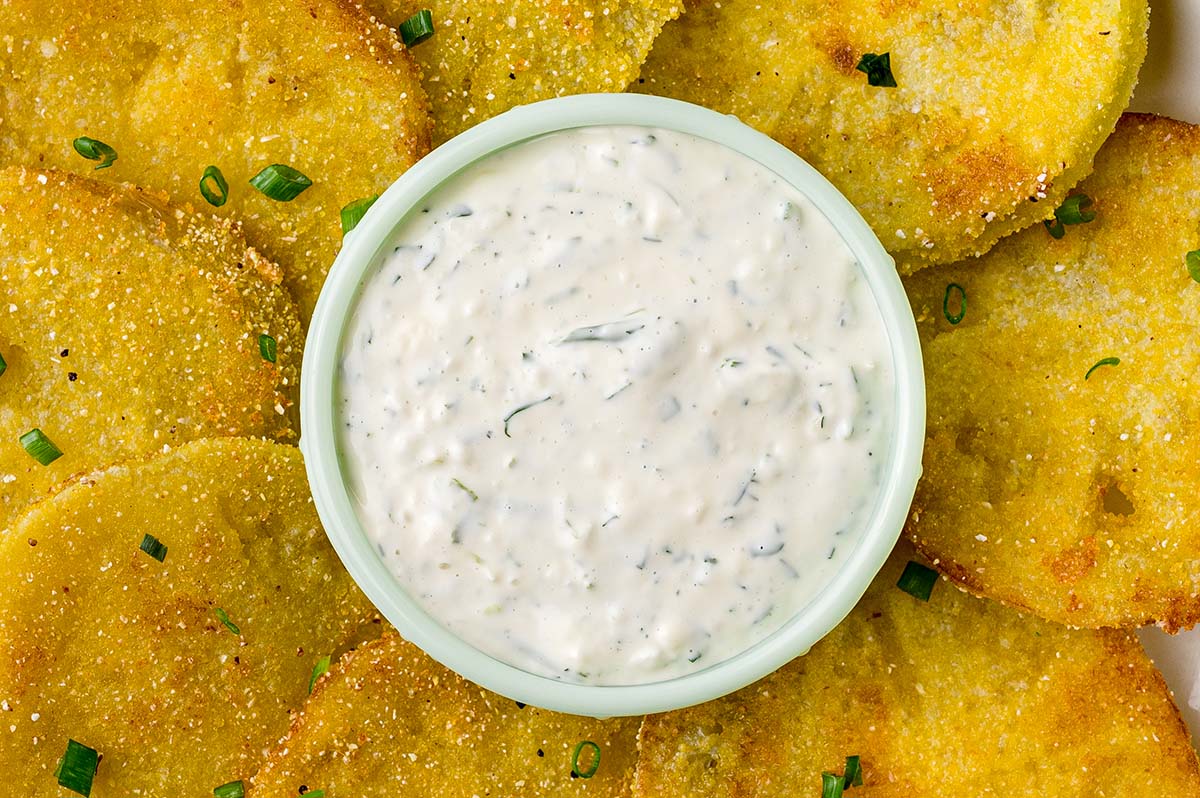 close of up of aioli dipping sauce surrounded by fried green tomatoes