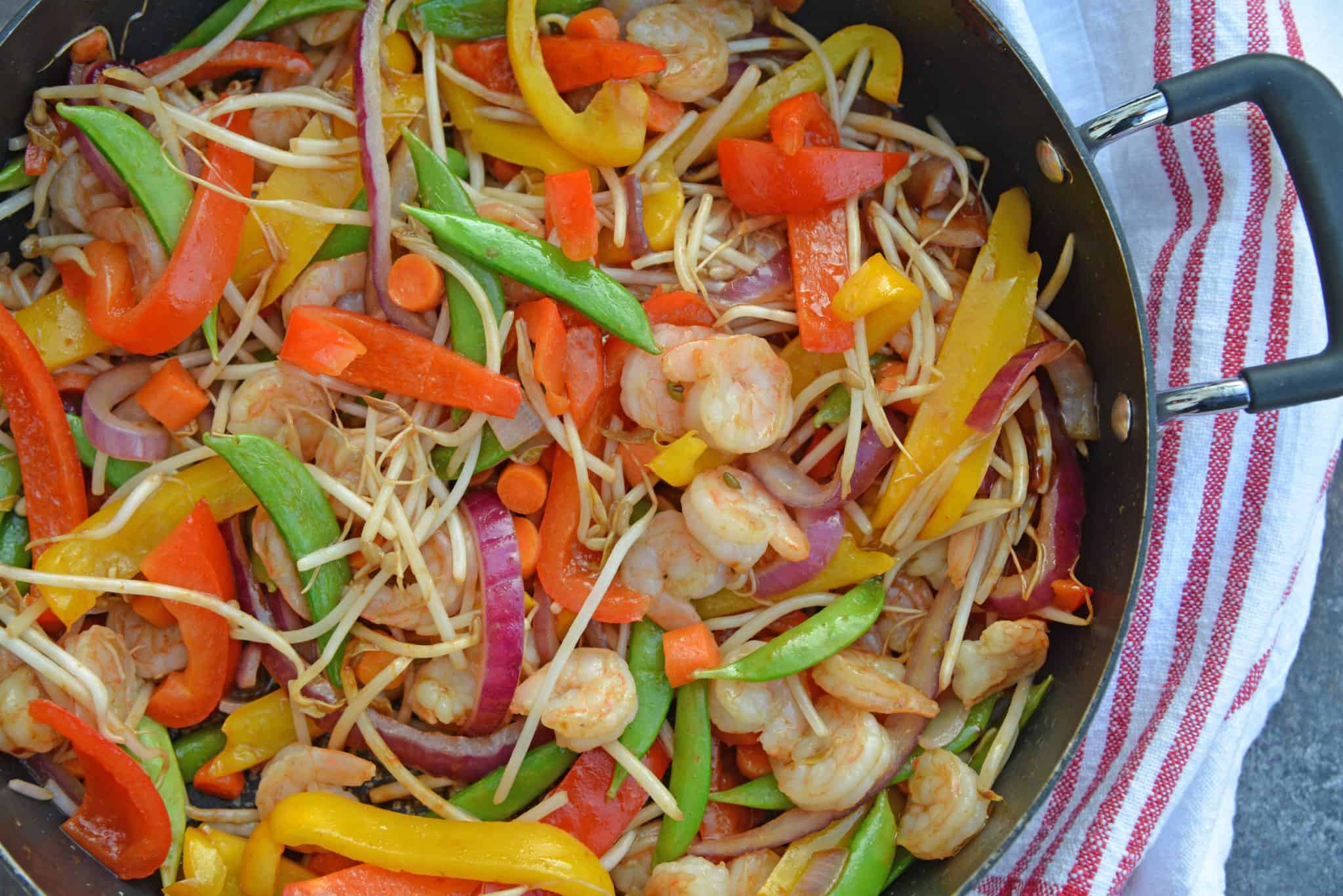 Skip the takeout and make this easy Teriyaki Shrimp Stir Fry instead! This Shrimp Stir Fry is an easy weeknight meal that the whole family will love! Best served with fried rice or noodles and packed full of veggies, this healthy recipe is sure to be a hit! #shrimpstirfry #teriyakirecipes #recipesthatuseteriyakisauce #teriyakishrimpstirfry #savoryexperiments 