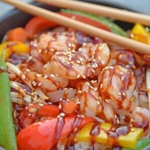 Skip the takeout and make this easy Teriyaki Shrimp Stir Fry instead! This Shrimp Stir Fry is an easy weeknight meal that the whole family will love! Best served with fried rice or noodles and packed full of veggies, this healthy recipe is sure to be a hit! #shrimpstirfry #teriyakirecipes #recipesthatuseteriyakisauce #teriyakishrimpstirfry #savoryexperiments