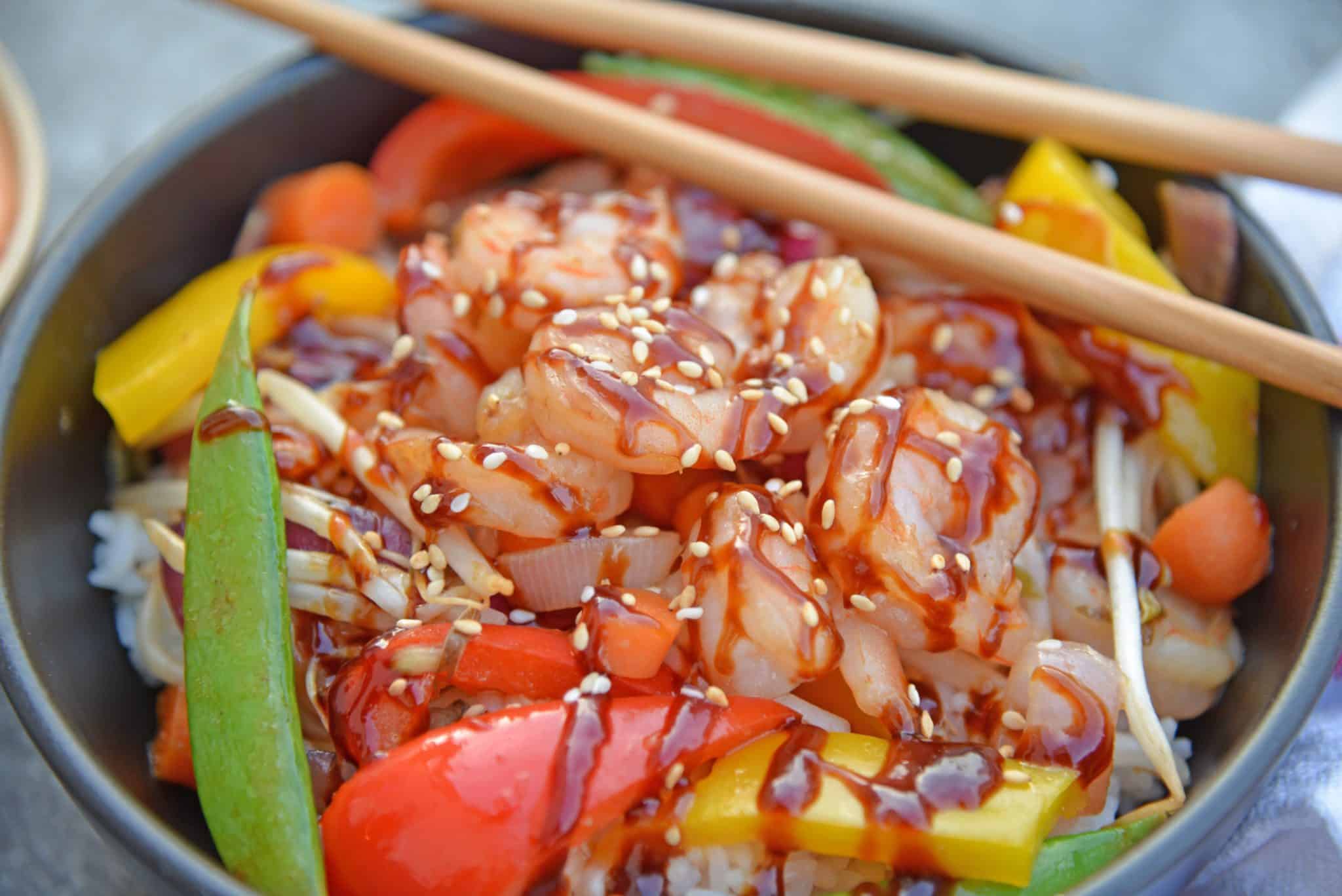 Skip the takeout and make this easy Teriyaki Shrimp Stir Fry instead! This Shrimp Stir Fry is an easy weeknight meal that the whole family will love! Best served with fried rice or noodles and packed full of veggies, this healthy recipe is sure to be a hit! #shrimpstirfry #teriyakirecipes #recipesthatuseteriyakisauce #teriyakishrimpstirfry #savoryexperiments