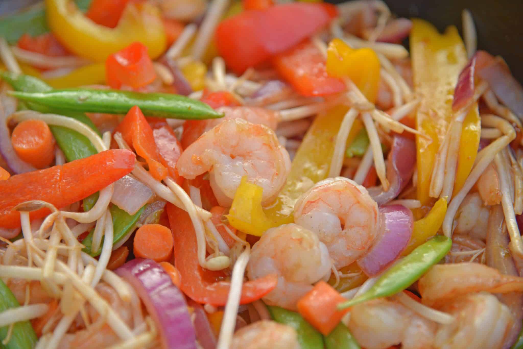 Skip the takeout and make this easy Teriyaki Shrimp Stir Fry instead! This Shrimp Stir Fry is an easy weeknight meal that the whole family will love! Best served with fried rice or noodles and packed full of veggies, this healthy recipe is sure to be a hit! #shrimpstirfry #teriyakirecipes #recipesthatuseteriyakisauce #teriyakishrimpstirfry #savoryexperiments 