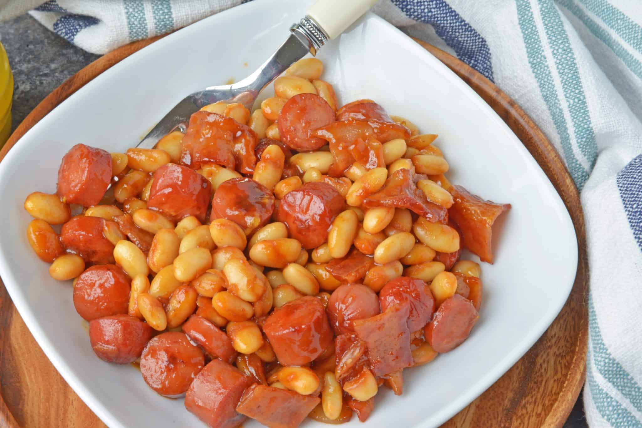 This Franks and Beans recipe is made with real beef hot dogs and less sugar than the canned version. Perfect as a quick and easy lunch or a classic camping food! #franksandbeans #homemadebeanieweenies www.savoryexperiments.com