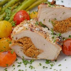Grilled Stuffed Pork Chops are an easy grilled pork recipe. Herb marinated pork is stuffed with bread crumbs, herbs and Parmesan cheese and grilled to flavorful perfection in just 15 minutes! #grilledporkchops #stuffedporkchops www.savoryexperiments.com