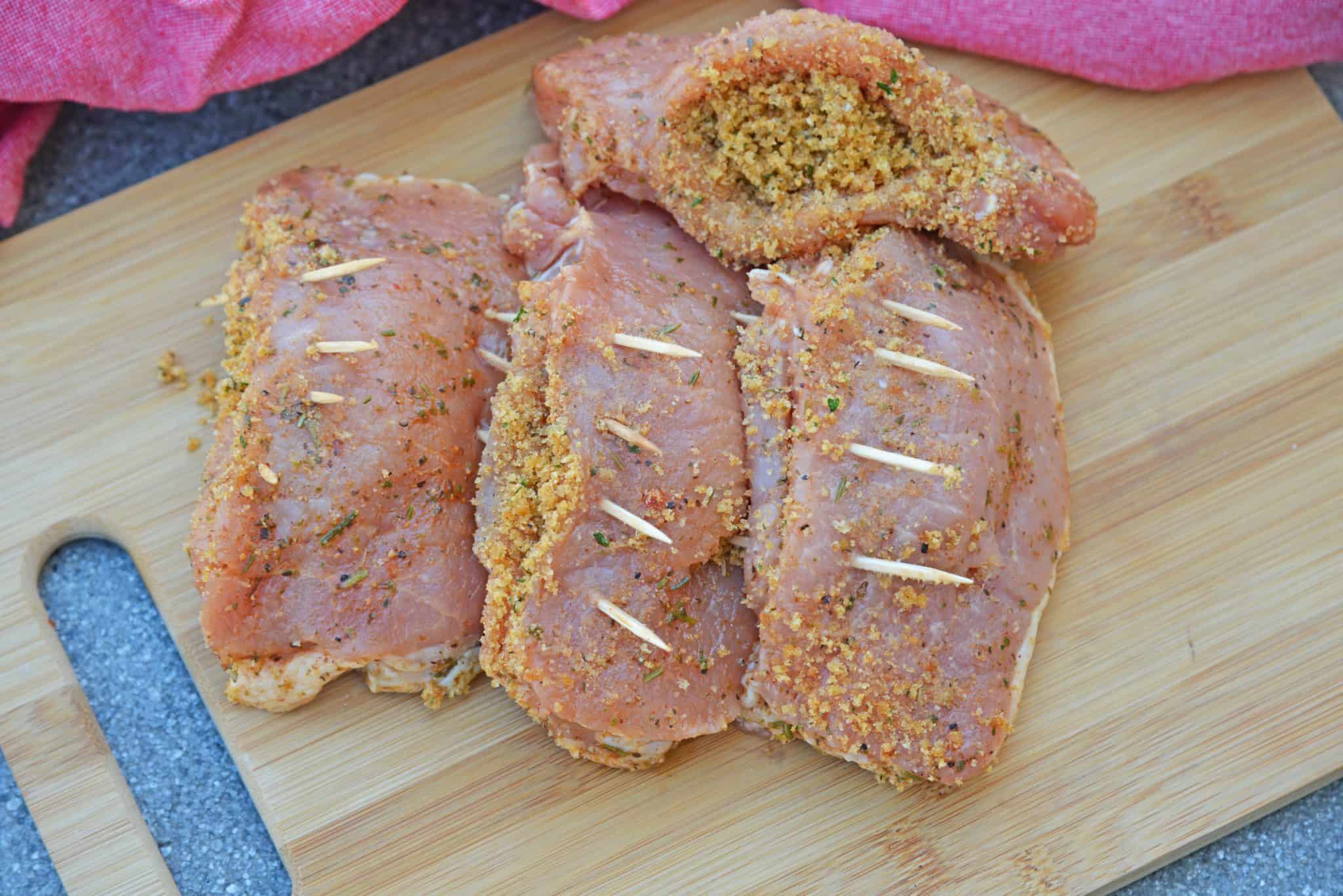 Grilled Stuffed Pork Chops are an easy grilled pork recipe. Herb marinated pork is stuffed with bread crumbs, herbs and Parmesan cheese and grilled to flavorful perfection in just 15 minutes! #grilledporkchops #stuffedporkchops www.savoryexperiments.com