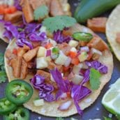 BBQ Pork Tacos are a colorful and easy weeknight dinner. Zesty BBQ sauce paired with sweet and spicy pineapple salsa and crunchy red cabbage. #porktacos #tacotuesday www.savoryexperiments.com