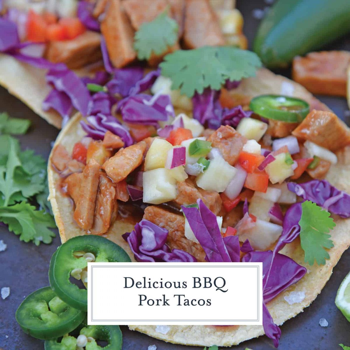 BBQ Pork Tacos are a colorful and easy weeknight dinner. Zesty BBQ sauce paired with sweet and spicy pineapple salsa and crunchy red cabbage. #porktacos #tacotuesday www.savoryexperiments.com