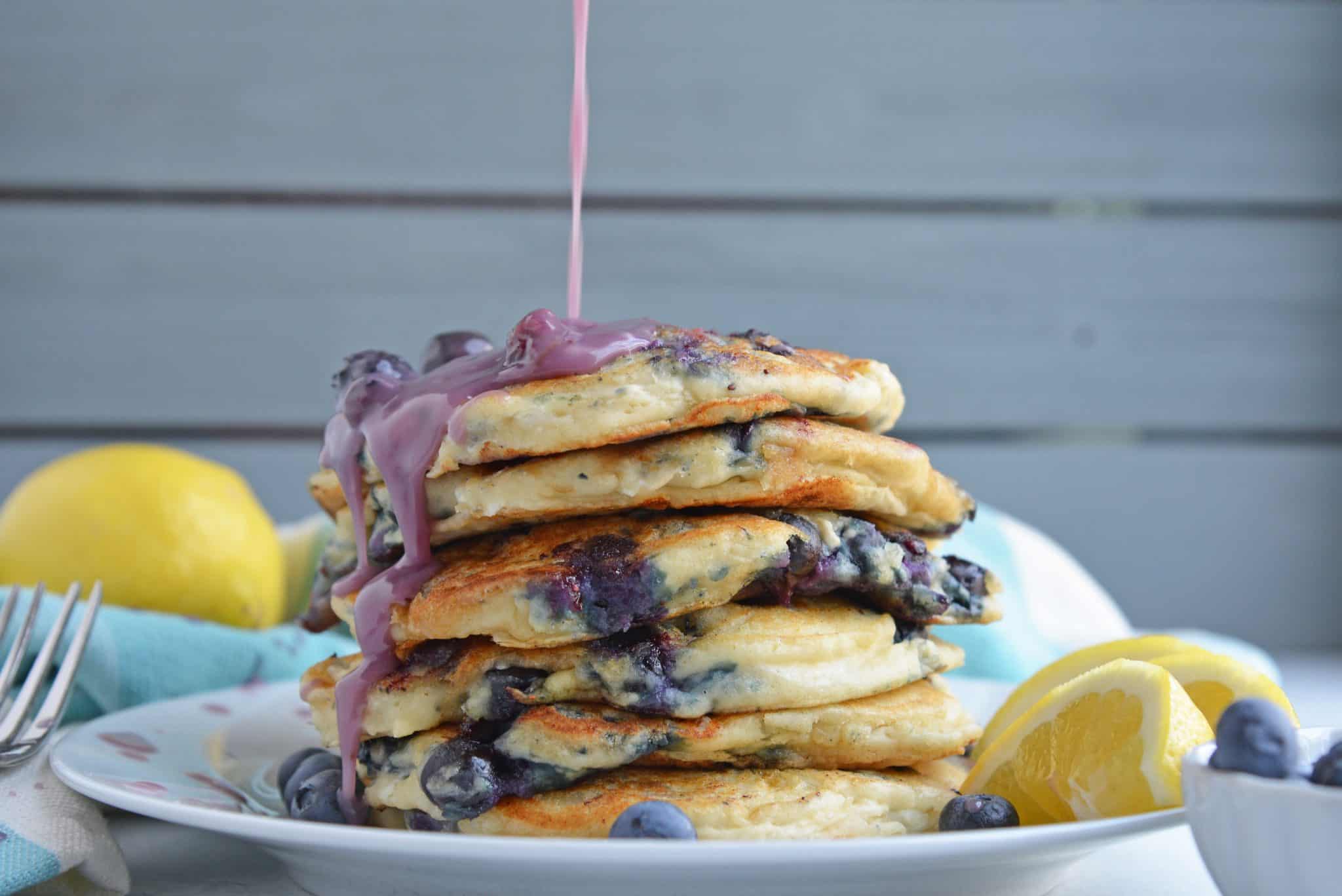 Stack of blueberry pancakes with blueberry syrup