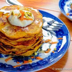 Stack of carrot pancakes on a blue plate