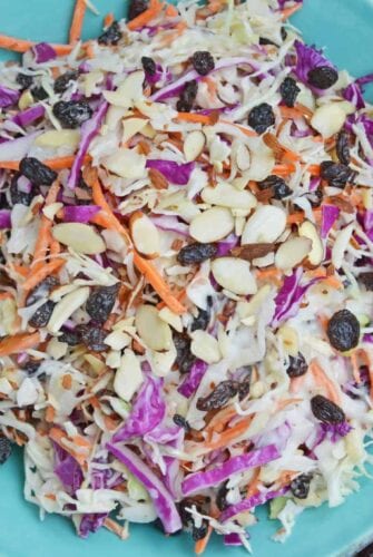 Creamy Coleslaw with almonds and raisins is an easy coleslaw recipe that is mix and serve. Coleslaw dressing, almonds, raisins and crisp cabbage mix are the perfect BBQ dish. #creamycoleslaw @coleslawrecipe www.savoryexperiments.com