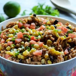 Close up of chicken burrito in white bowl