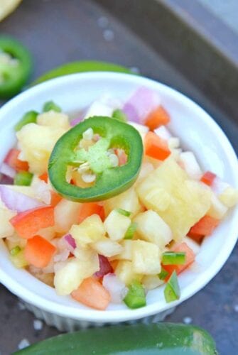 Looking for an easy homemade salsa recipe? With pineapple, jalapenos, peppers and lime juice, you can't go wrong with this Pineapple Salsa recipe! #pineapplesalsa #pineapplesalsarecipe #homemadesalsarecipe www.savoryexperiments.com
