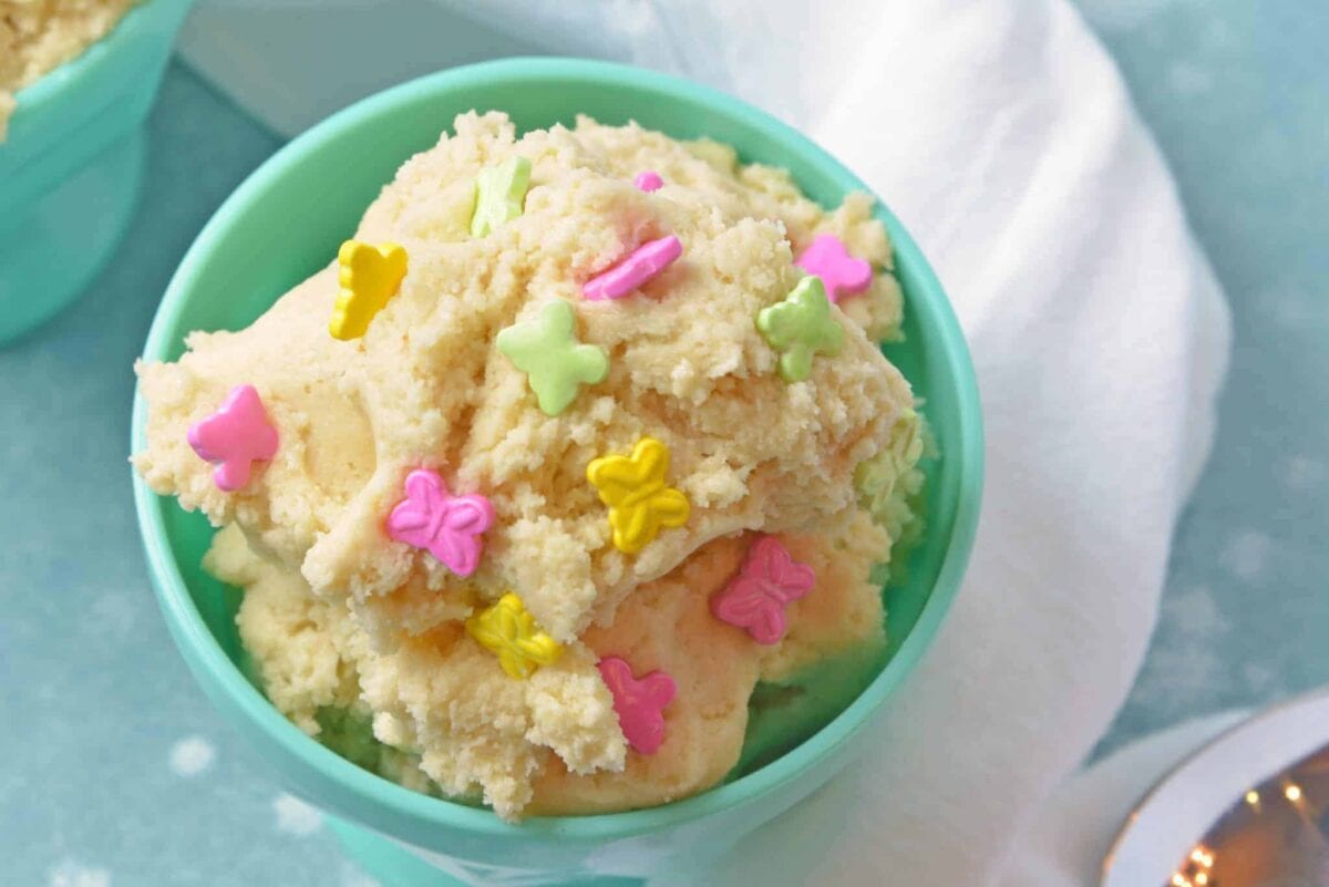 Close up of sugar cookie dough in a teal bowl
