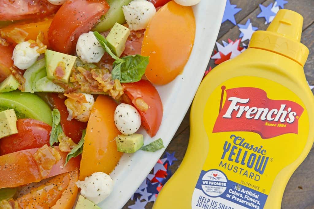 Tomato Salad with Mustard Bacon Dressing is the ultimate summer side dish using lush tomatoes, avocado mozzarella basil. Make it ahead for any party or BBQ. #tomatosalad #tomatorecipes www.savoryexperiments.com 