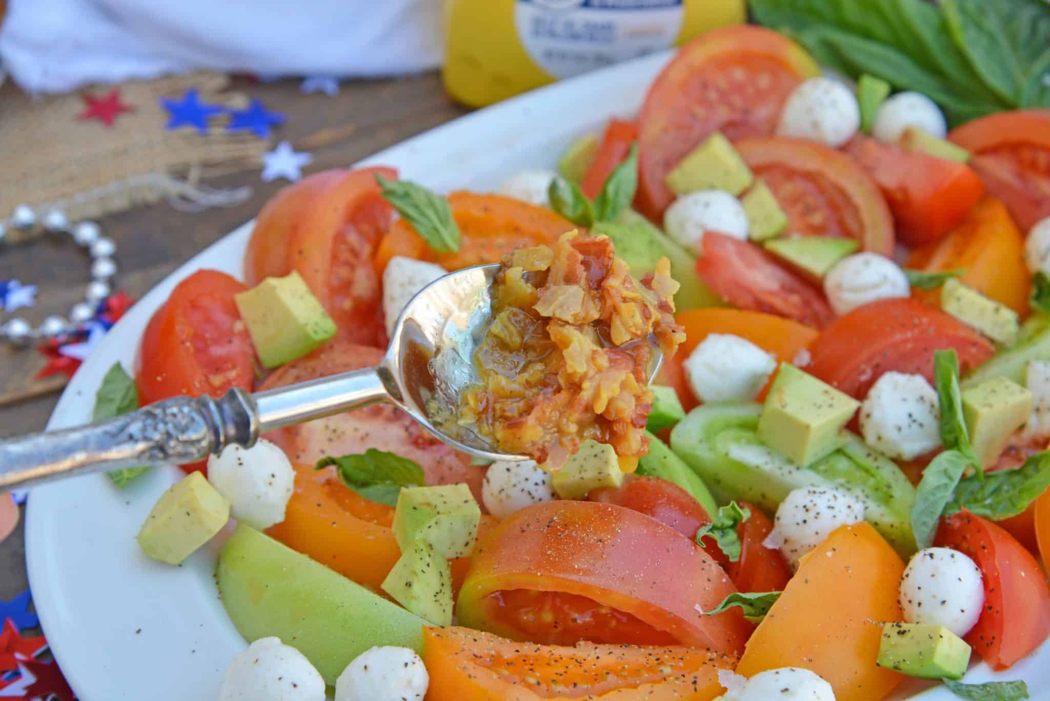 Tomato Salad with Mustard Bacon Dressing is the ultimate summer side dish using lush tomatoes, avocado mozzarella basil. Make it ahead for any party or BBQ. #tomatosalad #tomatorecipes www.savoryexperiments.com