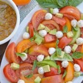 Tomato Salad with Mustard Bacon Dressing is the ultimate summer side dish using lush tomatoes, avocado mozzarella basil. Make it ahead for any party or BBQ. #tomatosalad #tomatorecipes www.savoryexperiments.com