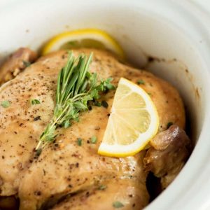 Close up of whole chicken in crock pot