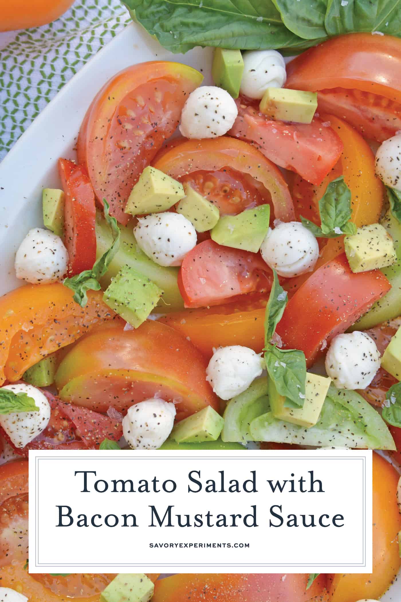 Tomato Salad with Mustard Bacon Dressing is the ultimate summer side dish using lush tomatoes, avocado mozzarella & basil. Make it ahead for any party or BBQ. #tomatosalad #tomatorecipes www.savoryexperiments.com