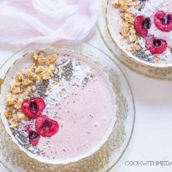 Cherry smoothie in a white bowl with toppings