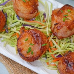 BBQ Bacon Wrapped Scallops are an easy and tasty seafood appetizer or dinner. With just a handful of ingredients, they're ready in just 15 minutes! #baconwrappedscallops #bakedscallops www.savoryexperiments.com