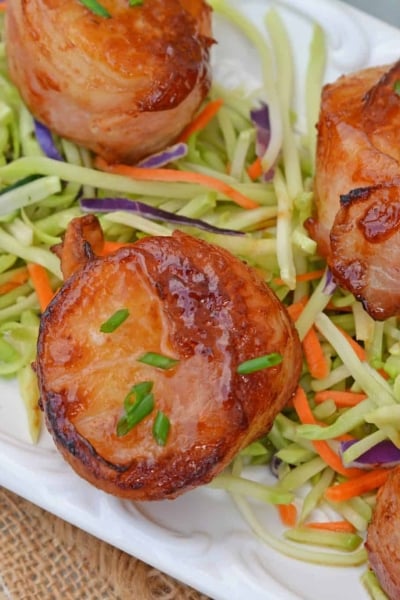 BBQ Bacon Wrapped Scallops are an easy and tasty seafood appetizer or dinner. With just a handful of ingredients, they're ready in just 15 minutes! #baconwrappedscallops #bakedscallops www.savoryexperiments.com