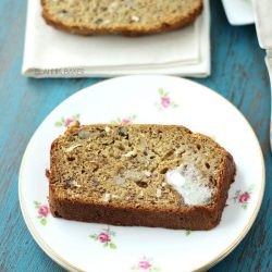A slice of banana coconut bread on a floral plate