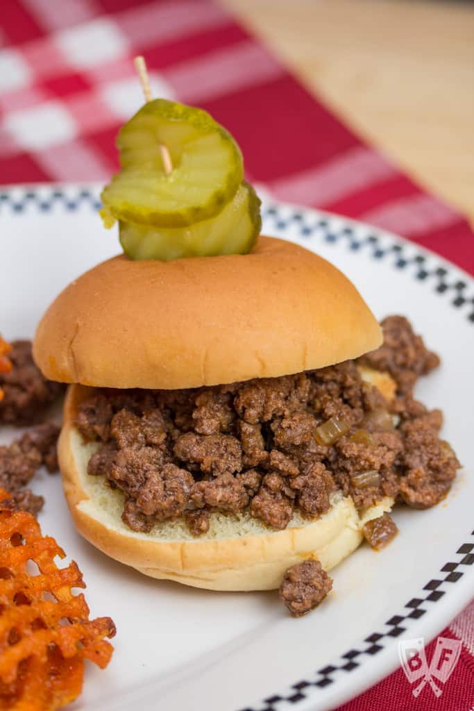 Sloppy joe on a plate with pickles