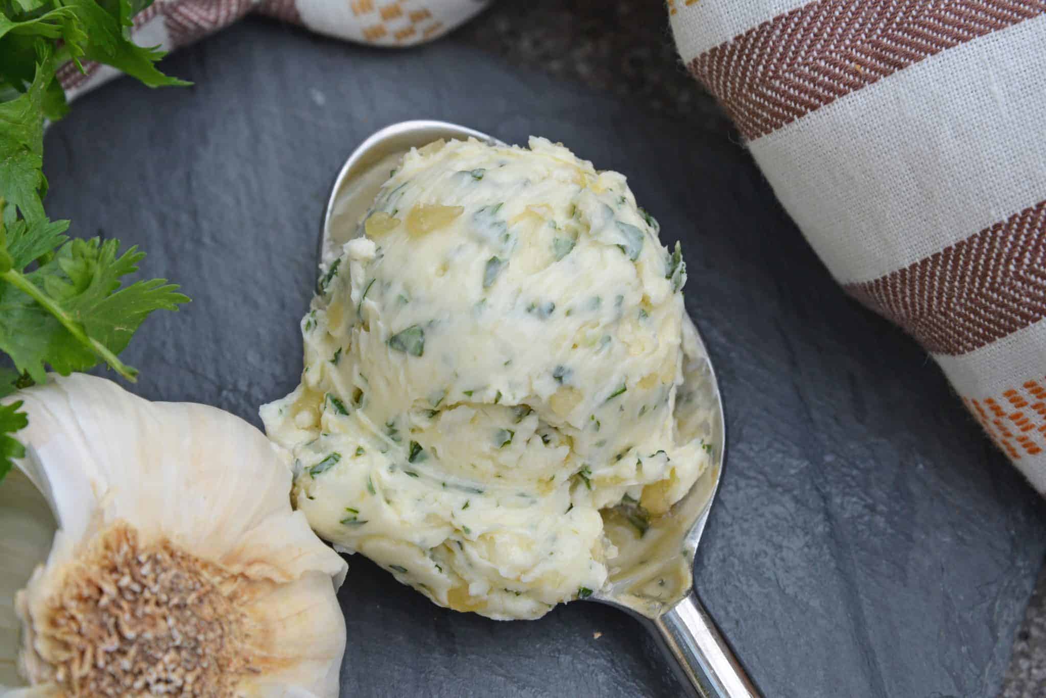homemade cognac butter recipe in a spoon with fresh garlic