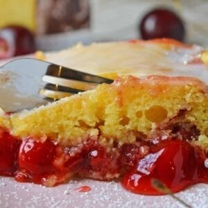 What is better than a Honey Bun Cake? A CHERRY Honey Bun Cake! Yellow cake mix laced with cinnamon, brown sugar and cherry pie filling, drizzled with almond glaze. #honeybuncake www.savoryexperiments.com