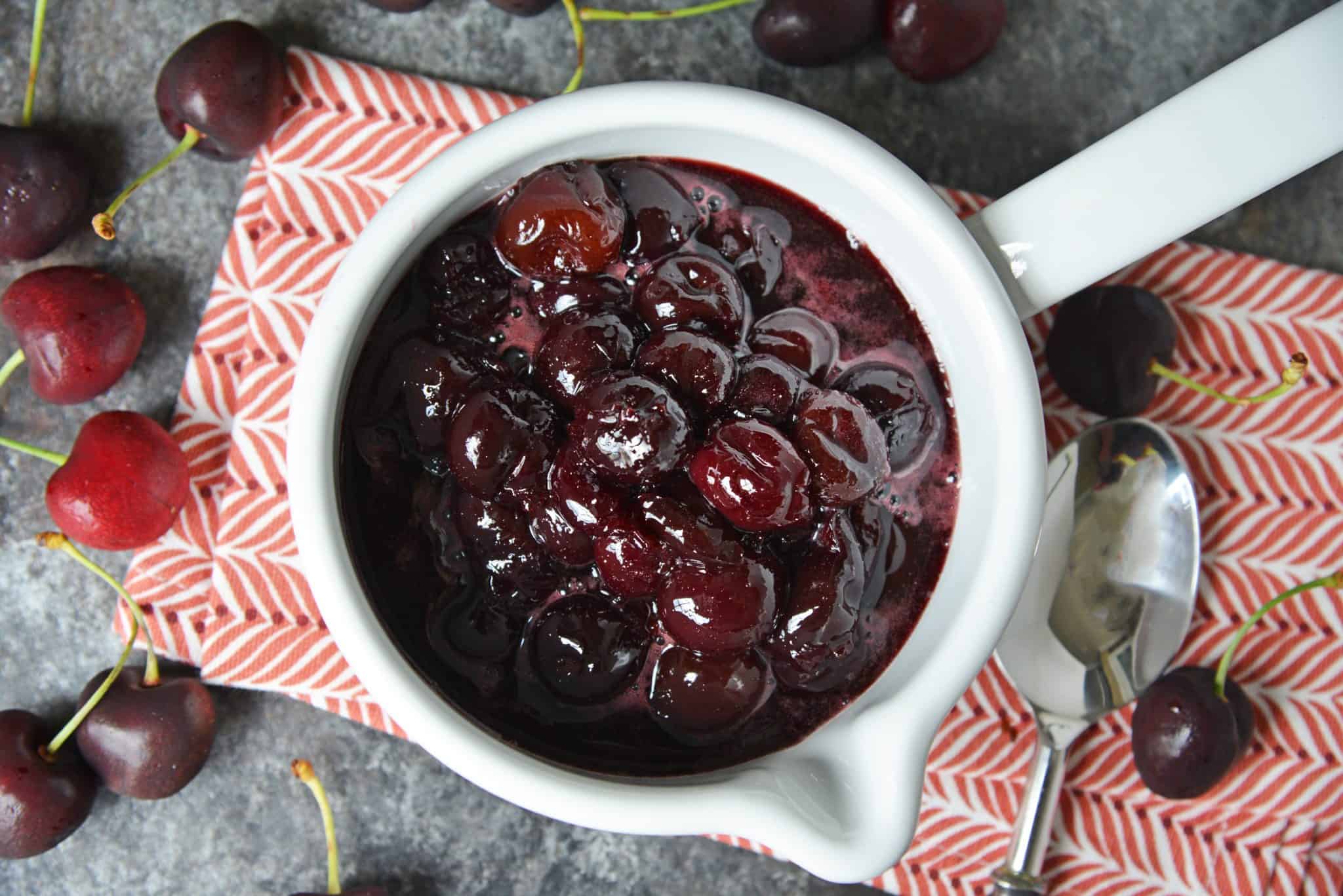 This Fresh Cherry Sauce is a yummy way to use fresh cherries. Spoon over ice cream, cake, waffles and more! #cherrysaucerecipe #freshcherryrecipes #desserttoppings www.savoryexperiments.com