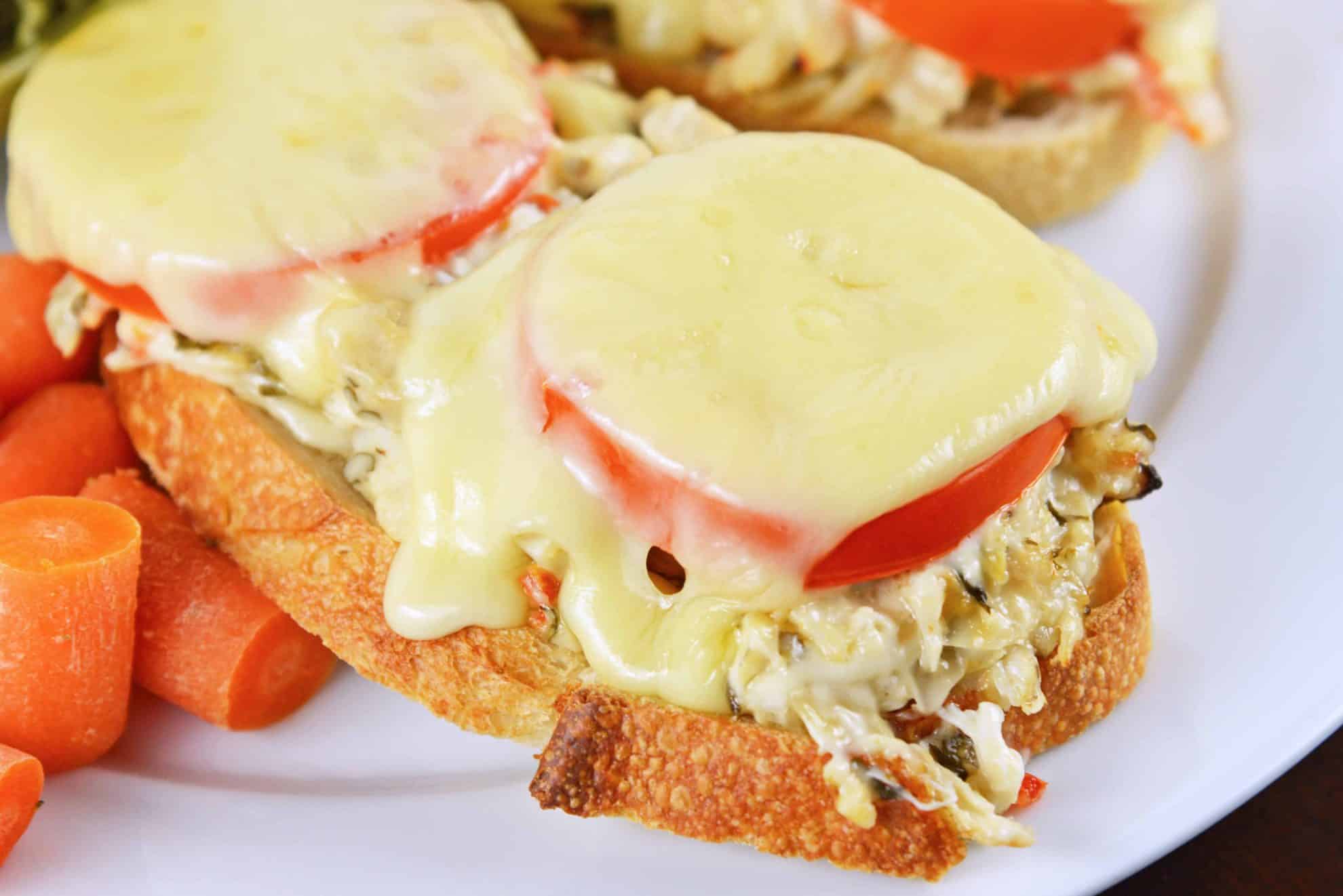 This Crab Melt will become your favorite open faced sandwich recipe! Deliciously cheesy and easy to make! #crabmelt #crabrecipes #openfacedsandwich www.savoryexperiments.com