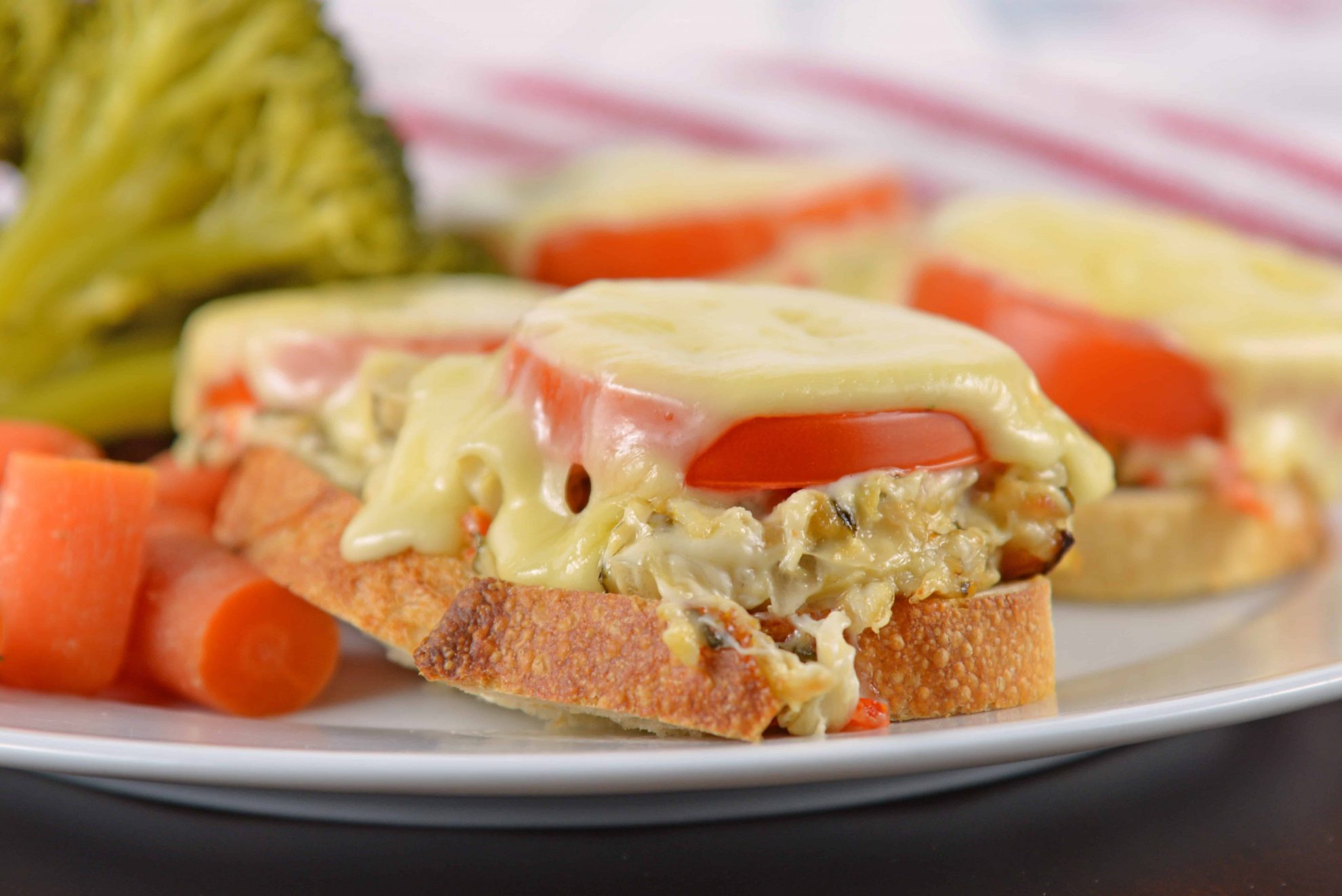 This Crab Melt will become your favorite open faced sandwich recipe! Deliciously cheesy and easy to make! #crabmelt #crabrecipes #openfacedsandwich www.savoryexperiments.com