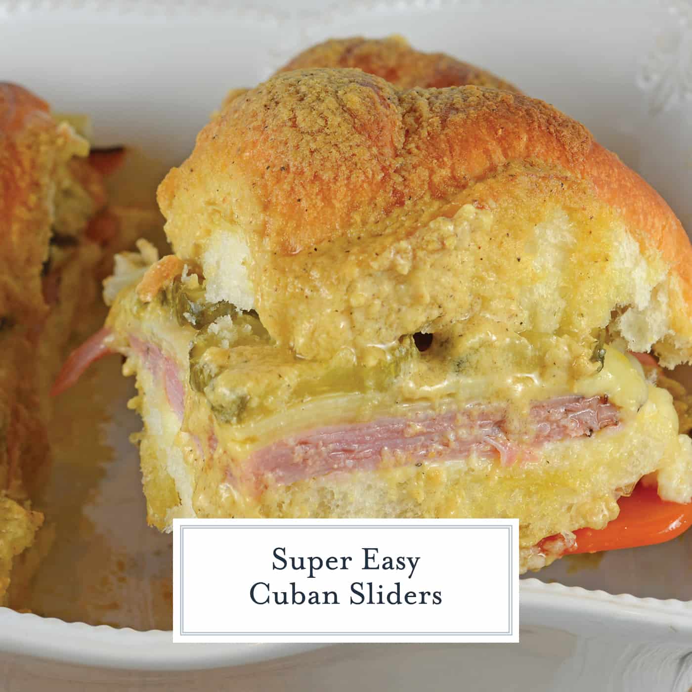 Cuban Sliders are made with layers of ham, pickles, and cheese between delicious sweet Hawaiian rolls. An easy and yummy appetizer! #cubansliders #minicubansandwiches www.savoryexperiments.com