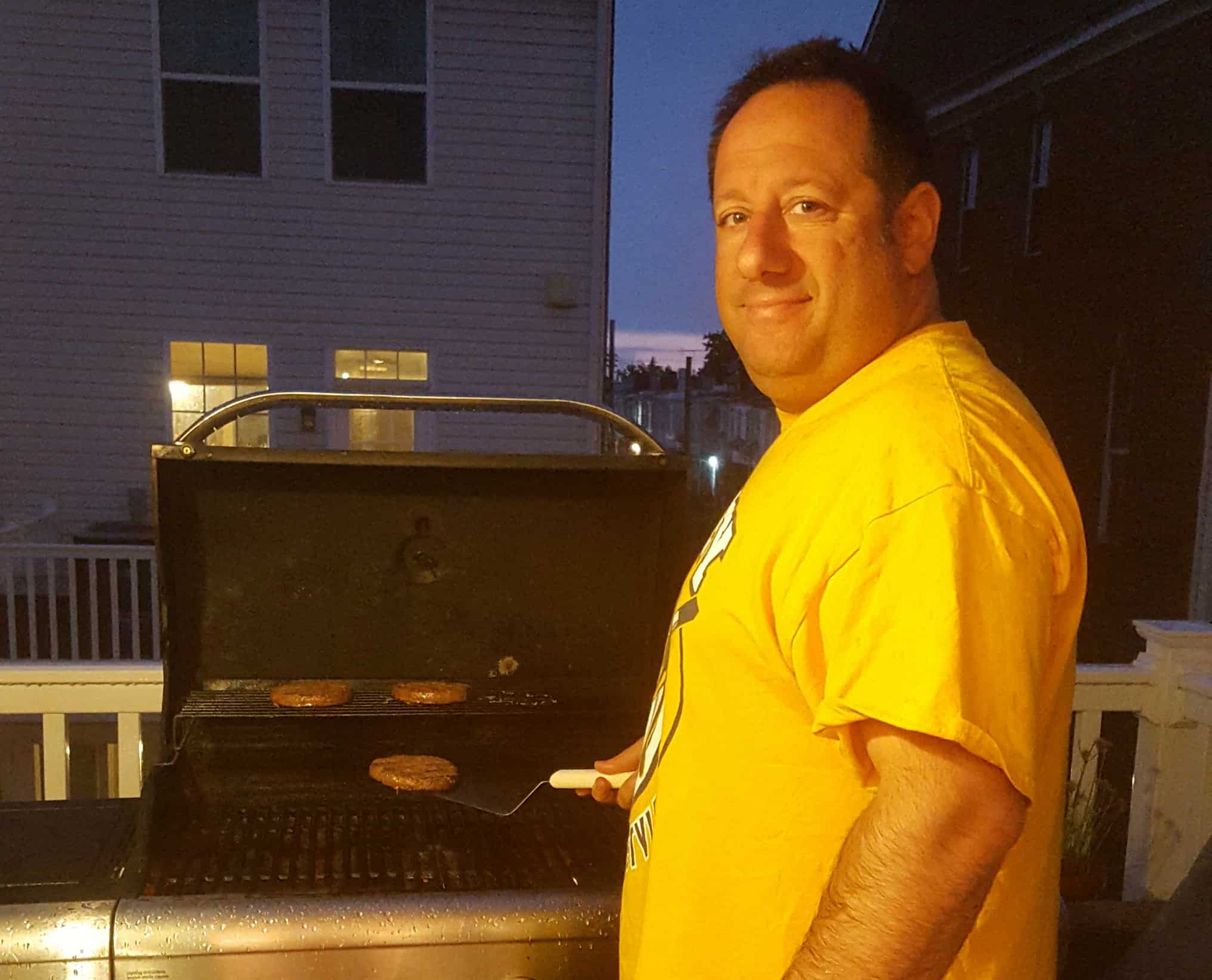 Hubby grilling burgers in the rain  