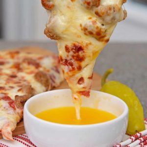 Close up of pizza dipping into Garlic Butter Sauce