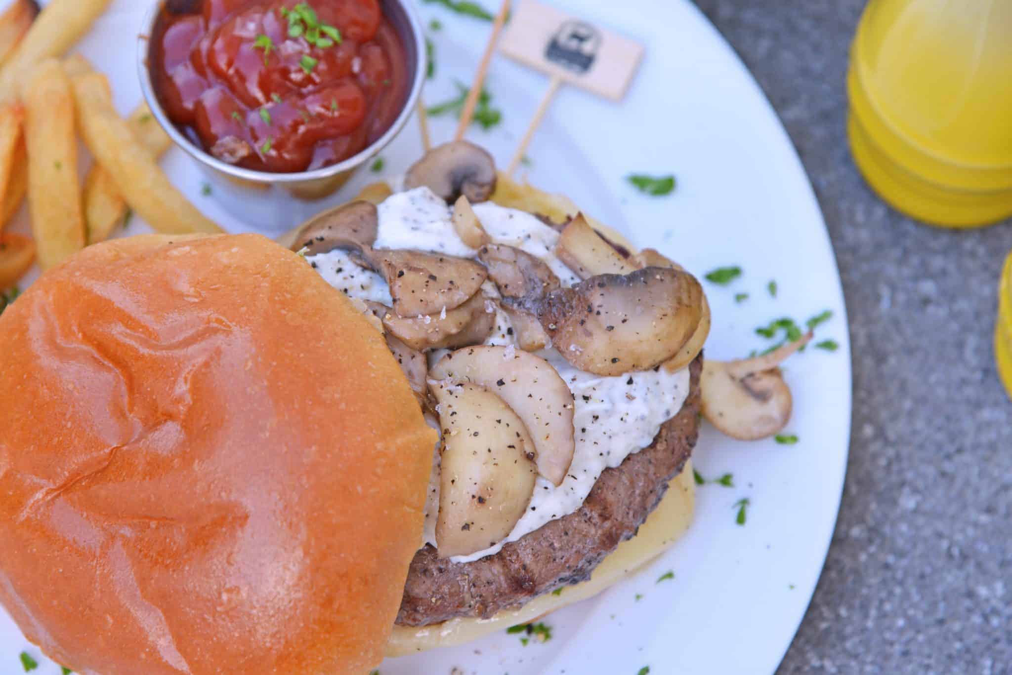 Garlic truffle burger with ketchup on a white plate