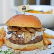 A Garlic Truffle Burger is the perfect way to make a gourmet burger at home. Truffle Aioli, sautéed mushrooms, Swiss cheese and a juicy burger patty on a buttery brioche roll. #gourmetburgers #truffleburgers www.savoryexperiments.com