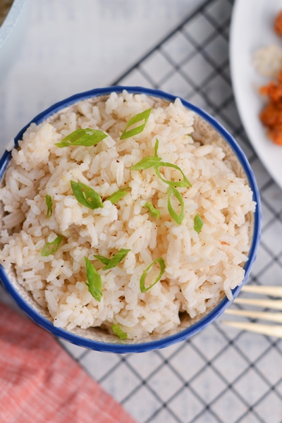 overhead of ginger rice next to orange chicken