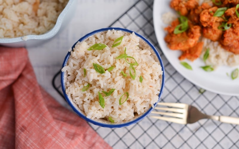 overhead of ginger rice next to orange chicken