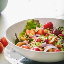 Honey quinoa cherry salad in a white bowl